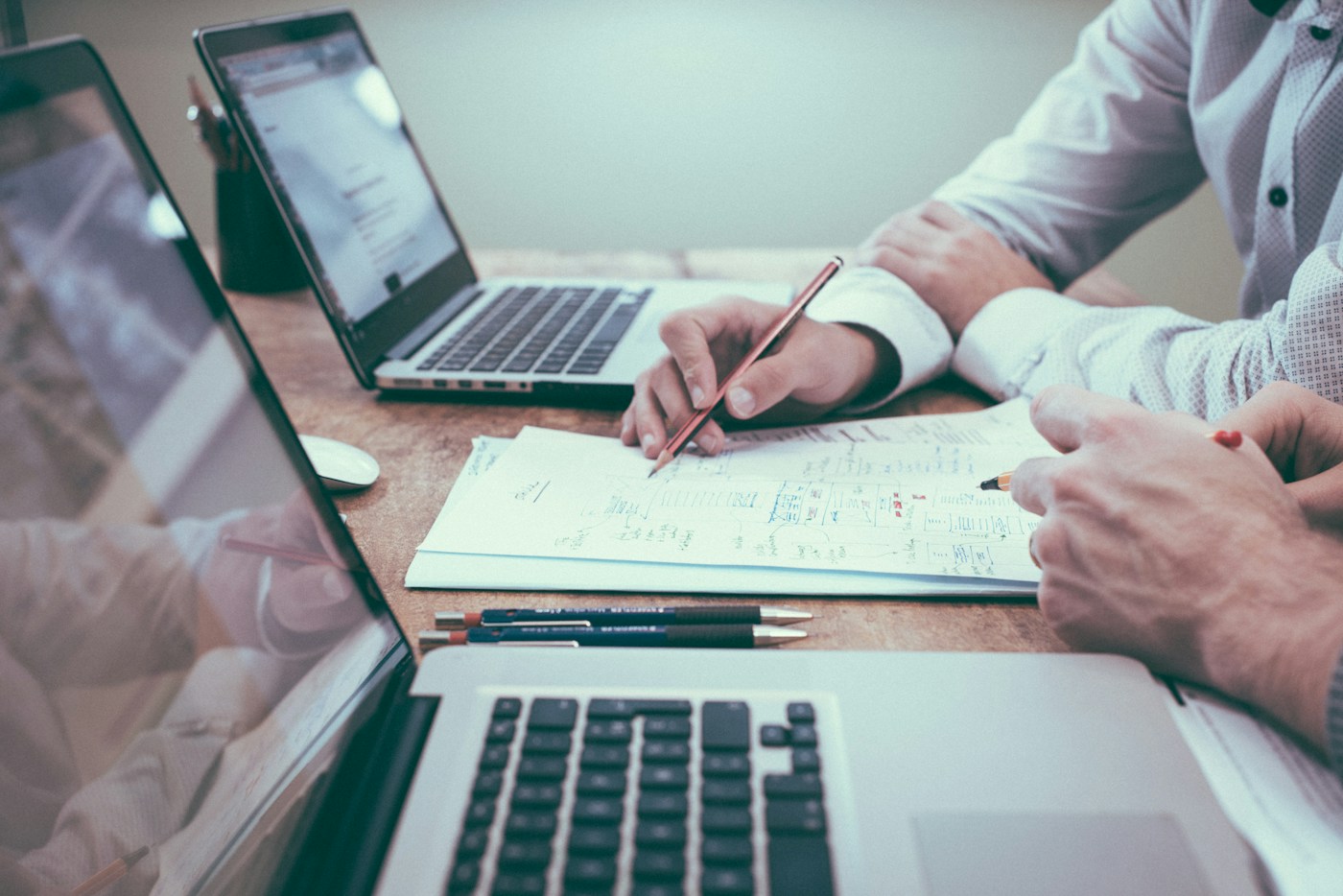 Colleagues reviewing financial charts and documents at a desk