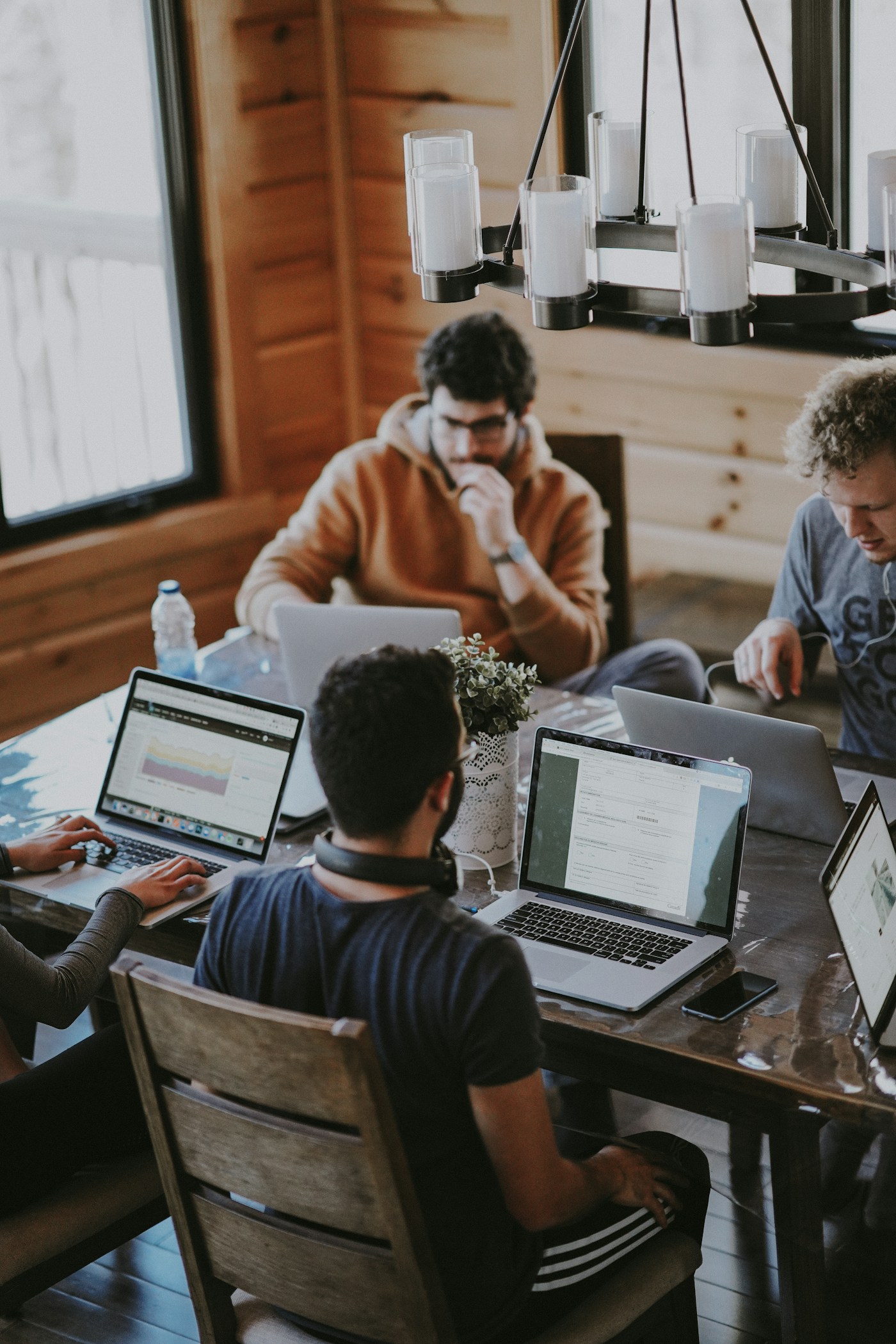 Business colleagues collaborating around laptops at a shared table